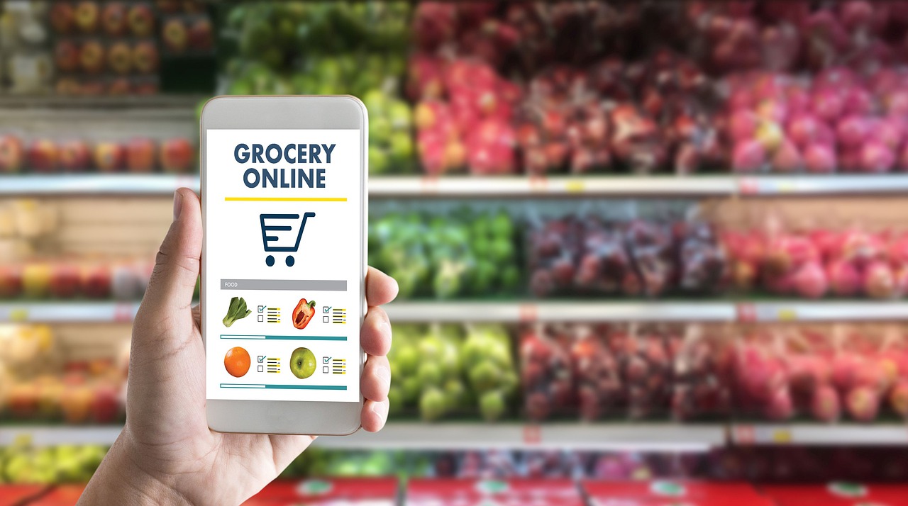 holding a phone up in a grocery store