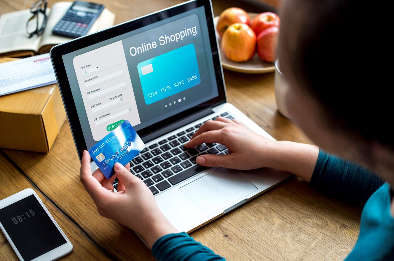 man feeding his credit card info into his laptop