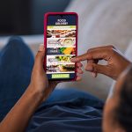 Woman ordering food online from home