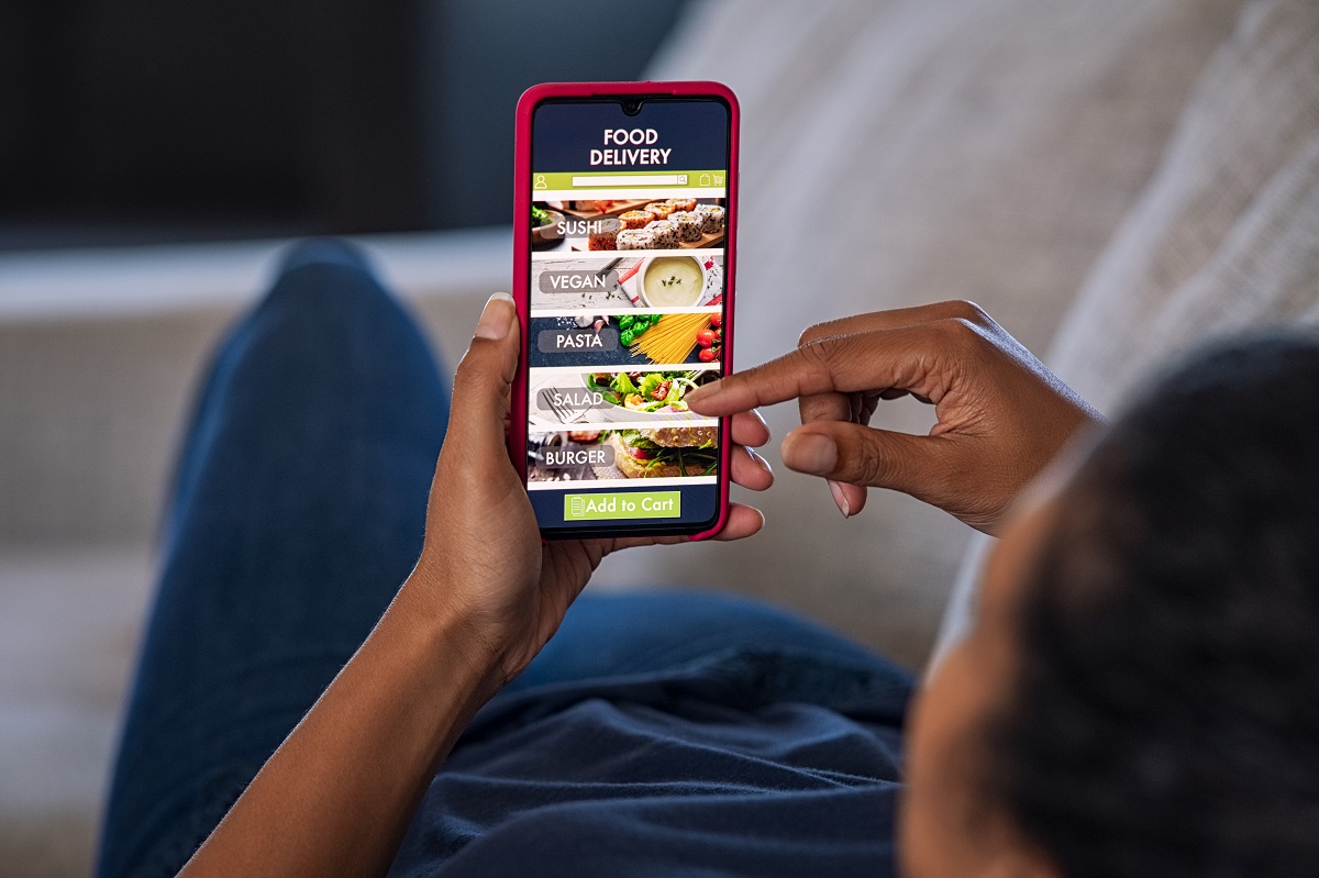 Woman ordering food online from home